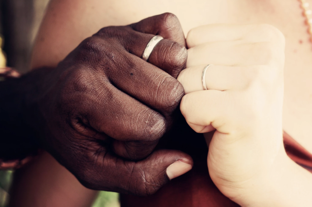 Couple displaying wedding bands